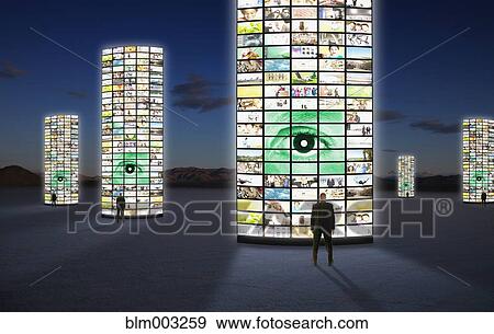 Businessmen standing next to pillars of television screens View Large Photo Image Stock Photo - Businessmen standing next to pillars of television screens. Fotosearch