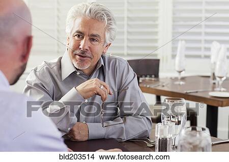Picture - Businessmen talking in cafe. Fotosearch