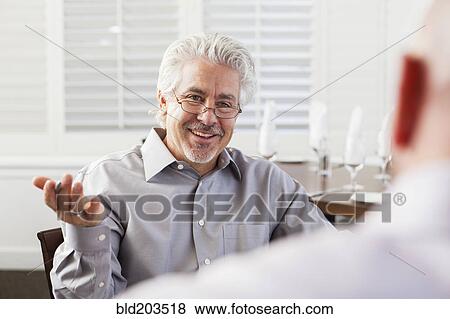 Businessmen talking in cafe View Large Photo Image Stock Photo - Businessmen talking in cafe. Fotosearch