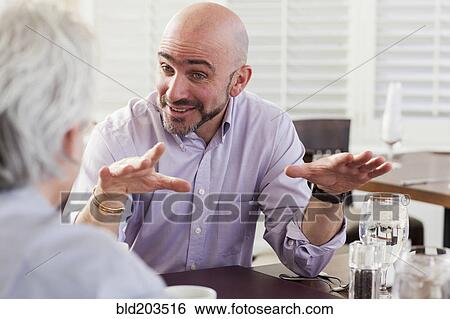 Stock Photograph - Businessmen talking in cafe. Fotosearch