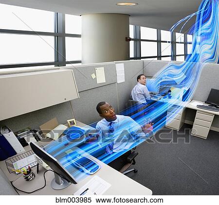Businessmen watching light stream between computers in office View Large Photo Image Stock Photography - Businessmen watching light stream between computers in office. Fotosearch