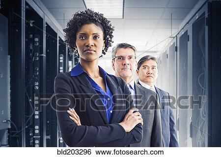 Stock Photograph - Businesspeople standing in office. Fotosearch