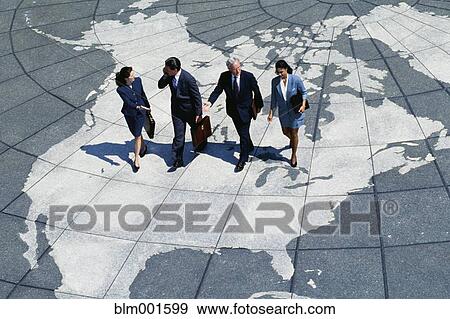 Stock Photo - Businesspeople walking on map of globe. Fotosearch