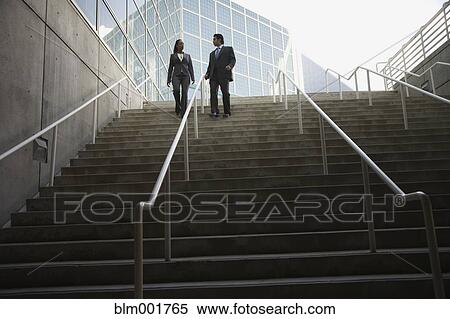 Businesswoman and businessman walking on stairs View Large Photo Image Stock Photography - Businesswoman and businessman walking on stairs. Fotosearch