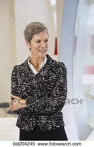 Businesswoman standing in hallway View Large Photo Image Stock Photography - Businesswoman standing in hallway. Fotosearch