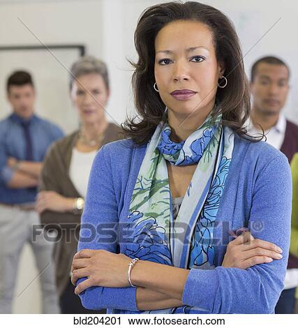 Businesswoman standing in office View Large Photo Image Stock Image - Businesswoman standing in office. Fotosearch