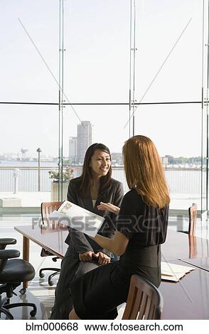 Stock Photo - Businesswomen in conference room for meeting. Fotosearch