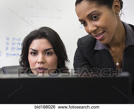 Stock Photograph - Businesswomen using computer in office. Fotosearch