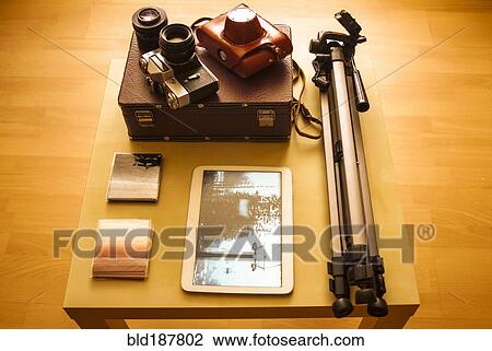 Stock Image - Camera equipment and digital tablet on table. Fotosearch