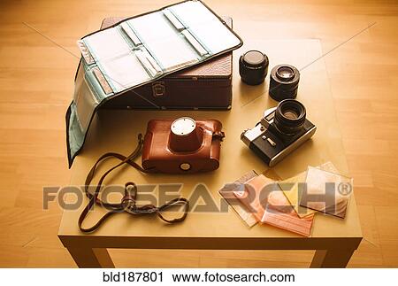Cameras, film and photographs on table View Large Photo Image Stock Image - Cameras, film and photographs on table. Fotosearch
