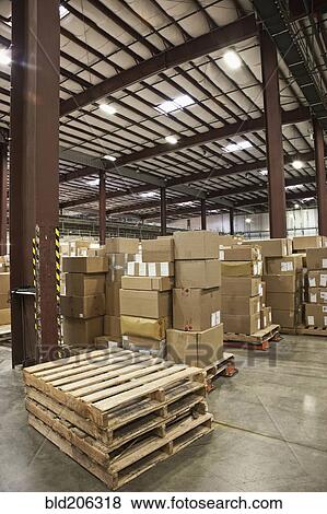 Stock Photo - Cardboard boxes and pallets in warehouse. Fotosearch
