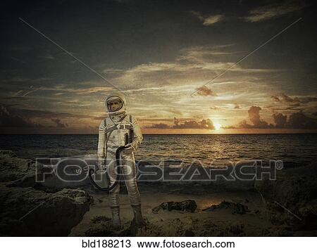 Caucasian astronaut standing on beach at sunset View Large Photo Image Stock Image - Caucasian astronaut standing on beach at sunset. Fotosearch
