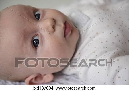 Picture - Caucasian baby laying on blanket. Fotosearch