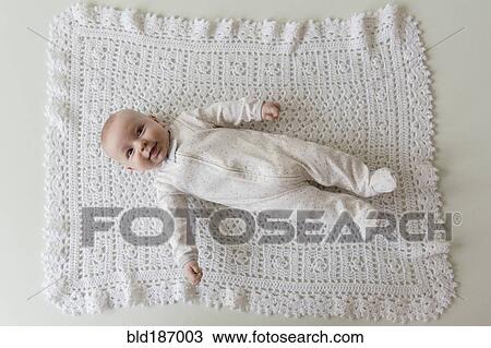 Stock Image - Caucasian baby laying on blanket. Fotosearch