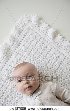Stock Photography - Caucasian baby laying on blanket. Fotosearch