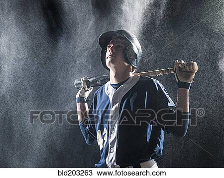 Caucasian baseball player standing in rain View Large Photo Image Stock Image - Caucasian baseball player standing in rain. Fotosearch