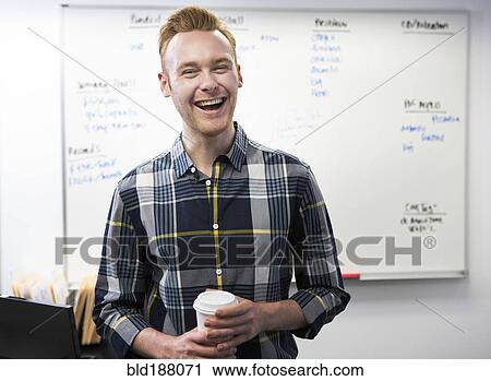 Caucasian businessman drinking coffee in office View Large Photo Image Stock Image - Caucasian businessman drinking coffee in office. Fotosearch