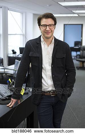 Stock Photograph - Caucasian businessman smiling in office. Fotosearch