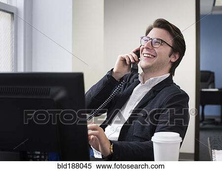 Caucasian businessman talking on telephone in office View Large Photo Image Stock Photography - Caucasian businessman talking on telephone in office. Fotosearch