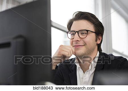 Stock Image - Caucasian businessman using computer in office. Fotosearch