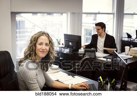 Picture - Caucasian businesswoman smiling in office. Fotosearch