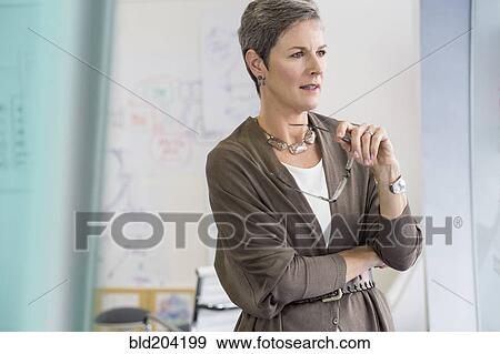Stock Photo - Caucasian businesswoman thinking in office. Fotosearch