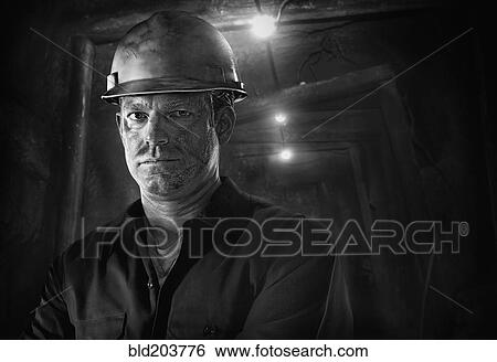 Stock Photograph - Caucasian carpenter wearing hard hat. Fotosearch