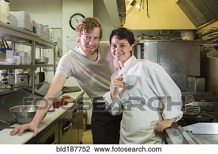 Caucasian chef and waiter smiling in restaurant kitchen View Large Photo Image Stock Image - Caucasian chef and waiter smiling in restaurant kitchen. Fotosearch