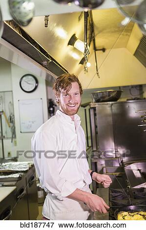 Caucasian chef cooking in restaurant kitchen View Large Photo Image Stock Photo - Caucasian chef cooking in restaurant kitchen. Fotosearch