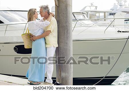 Caucasian couple hugging on dock View Large Photo Image Stock Image - Caucasian couple hugging on dock. Fotosearch