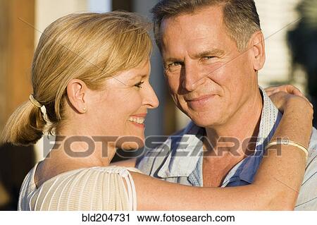 Caucasian couple hugging outdoors View Large Photo Image Stock Image - Caucasian couple hugging outdoors. Fotosearch