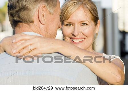 Caucasian couple hugging outdoors View Large Photo Image Stock Photo - Caucasian couple hugging outdoors. Fotosearch
