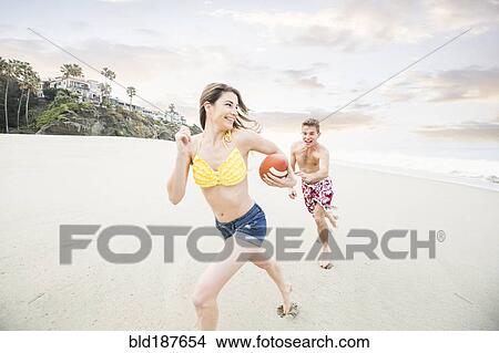 Caucasian couple playing on beach View Large Photo Image Picture - Caucasian couple playing on beach. Fotosearch