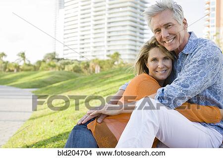 Picture - Caucasian couple relaxing in city park. Fotosearch