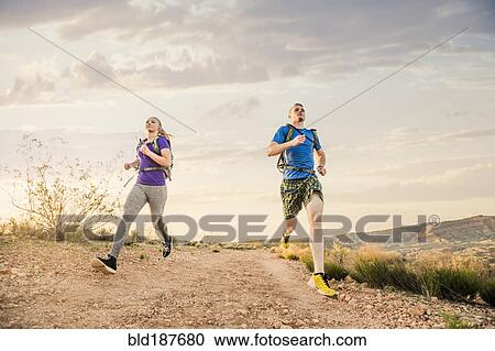 Caucasian couple running on remote hilltop View Large Photo Image Stock Image - Caucasian couple running on remote hilltop. Fotosearch