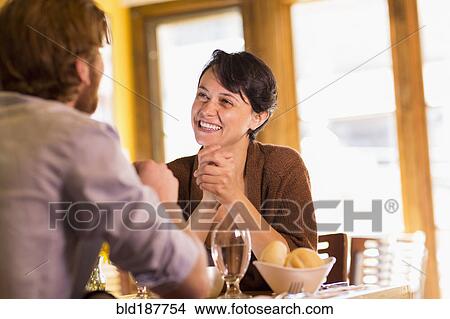 Picture - Caucasian couple talking in restaurant. Fotosearch