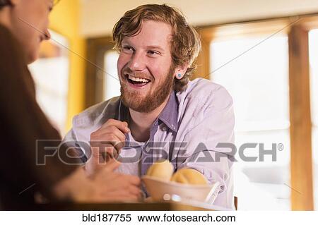 Stock Photography - Caucasian couple talking in restaurant. Fotosearch