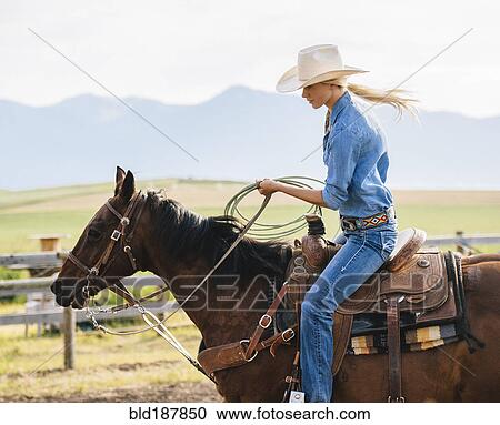 Caucasian cowgirl holding lasso on horseback View Large Photo Image Stock Image - Caucasian cowgirl holding lasso on horseback. Fotosearch