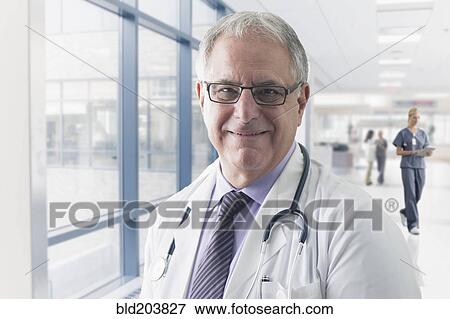 Stock Photo - Caucasian doctor smiling in hospital. Fotosearch