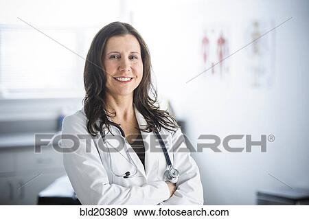 Caucasian doctor smiling in office View Large Photo Image Stock Photo - Caucasian doctor smiling in office. Fotosearch