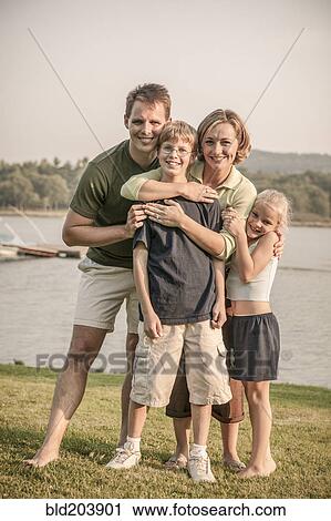 Caucasian family smiling in rural landscape View Large Photo Image Stock Image - Caucasian family smiling in rural landscape. Fotosearch