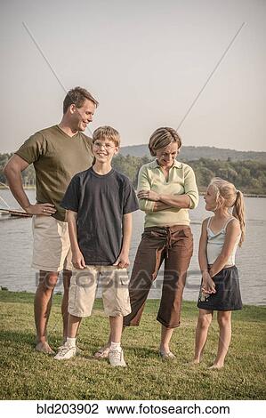 Caucasian family smiling in rural landscape View Large Photo Image Stock Image - Caucasian family smiling in rural landscape. Fotosearch