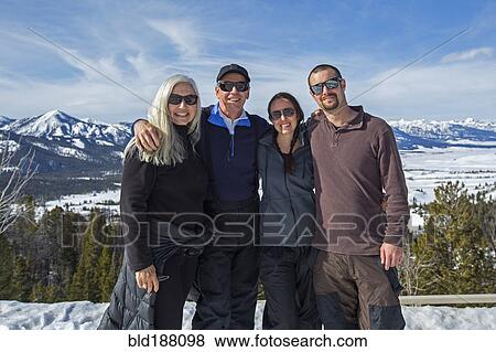 Stock Photo - Caucasian family smiling near remote landscape view. Fotosearch