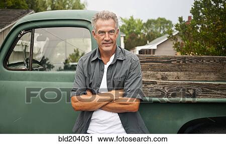 Caucasian farmer leaning against truck outdoors View Large Photo Image Stock Image - Caucasian farmer leaning against truck outdoors. Fotosearch