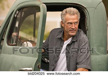Caucasian farmer sitting in truck View Large Photo Image Stock Photography - Caucasian farmer sitting in truck. Fotosearch