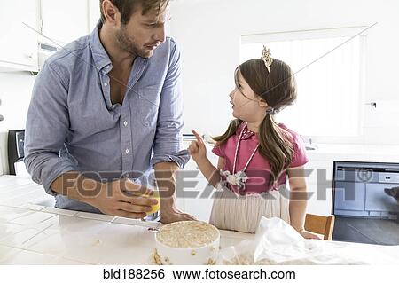 Caucasian father and daughter eating cereal in kitchen View Large Photo Image Stock Photograph - Caucasian father and daughter eating cereal in kitchen. Fotosearch