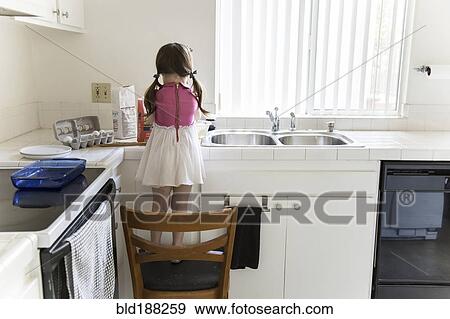 Caucasian girl baking in kitchen View Large Photo Image Stock Photo - Caucasian girl baking in kitchen. Fotosearch