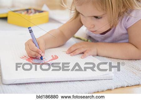 Stock Image - Caucasian girl drawing on floor. Fotosearch
