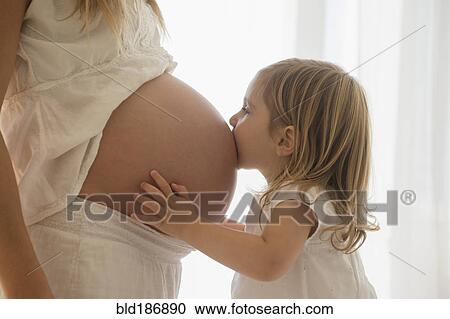 Caucasian girl kissing belly of pregnant mother View Large Photo Image Stock Image - Caucasian girl kissing belly of pregnant mother. Fotosearch