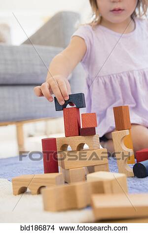 Caucasian girl playing with wooden blocks View Large Photo Image Picture - Caucasian girl playing with wooden blocks. Fotosearch